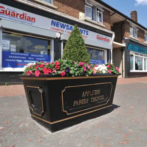 Black and gold Broxap planter with good depth situated on UK high street